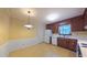 Bright kitchen with vintage tile flooring, white appliances, and a classic pendant light at 1116 Little Creek Rd, Durham, NC 27713