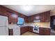 Functional kitchen featuring wood cabinets, standard appliances, and ample natural light at 1116 Little Creek Rd, Durham, NC 27713