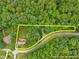 Aerial view outlining the property and land surrounded by lush green trees at 1124 Kalworth Rd, Wake Forest, NC 27587