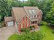 An aerial view of a brick home featuring a spacious layout, and a two-car garage at 1124 Kalworth Rd, Wake Forest, NC 27587