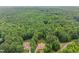 Aerial view of the property showcasing lush surrounding trees and landscaping at 1124 Kalworth Rd, Wake Forest, NC 27587