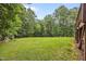 Expansive backyard with lush green grass and mature trees, perfect for outdoor activities at 1124 Kalworth Rd, Wake Forest, NC 27587