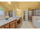 A spacious bathroom features double sinks, a large mirror, and a separate tub and shower at 1124 Kalworth Rd, Wake Forest, NC 27587