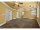 Spacious bedroom with a decorative tray ceiling, carpet flooring, and lots of natural light at 1124 Kalworth Rd, Wake Forest, NC 27587