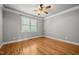 A bright, empty bedroom featuring hardwood floors and neutral walls at 1124 Kalworth Rd, Wake Forest, NC 27587