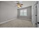 Cozy bedroom with neutral carpet, ceiling fan, and natural light from a window at 1124 Kalworth Rd, Wake Forest, NC 27587