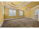 Large bedroom featuring a ceiling fan, tray ceiling, and multiple windows for ample sunlight at 1124 Kalworth Rd, Wake Forest, NC 27587