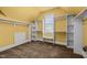 Walk-in closet features carpeted floors, built-in shelving, and natural light from a window at 1124 Kalworth Rd, Wake Forest, NC 27587