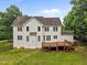 Back exterior view of house with spacious grassy backyard and wooden deck at 1124 Kalworth Rd, Wake Forest, NC 27587