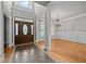 Grand foyer and adjacent room with hardwood floors, chandelier, and trim at 1124 Kalworth Rd, Wake Forest, NC 27587