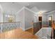 Bright hallway features hardwood floors, decorative chandelier, and a view to the outside at 1124 Kalworth Rd, Wake Forest, NC 27587