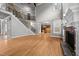 Beautiful living room adjacent to a kitchen, featuring a staircase and fireplace at 1124 Kalworth Rd, Wake Forest, NC 27587