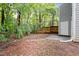 A spacious backyard with a door to the house, a partial fence, and natural greenery, creating a serene outdoor space at 118 Rhum Pl, Garner, NC 27529