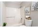 A full tub and shower combination in the bathroom with decor at 118 Rhum Pl, Garner, NC 27529