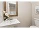 Half bathroom includes a pedestal sink, mirror, and toilet at 118 Rhum Pl, Garner, NC 27529