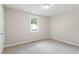 Bedroom with carpeting, neutral walls, window, and a closet door at 118 Rhum Pl, Garner, NC 27529