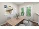 Cozy dining room featuring a rustic table and a view of the lush backyard through French doors at 118 Rhum Pl, Garner, NC 27529