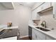 Modern kitchen with white cabinets, stainless steel appliances, quartz countertops, and tiled backsplash at 118 Rhum Pl, Garner, NC 27529