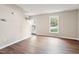 Spacious living room features hardwood floors, fresh paint, a large window, and natural light at 118 Rhum Pl, Garner, NC 27529