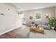 Open-concept living room with hardwood floors, a neutral color palette and an open doorway at 118 Rhum Pl, Garner, NC 27529