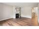Spacious living room features hardwood flooring and a cozy fireplace at 118 Rhum Pl, Garner, NC 27529