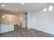 Bright kitchen with white cabinets, breakfast bar, and open access to dining room with stylish chandelier at 120 Newport Lndg # 99, Garner, NC 27529