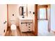 This bathroom offers a modern design with a white vanity, black accents, and a wood-framed doorway at 1283 Ennis Rd, Angier, NC 27501