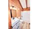 A wood-walled bathroom features a white vanity, toilet, shower, and light-colored flooring at 1283 Ennis Rd, Angier, NC 27501