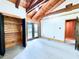 A bedroom has a gray carpet, wood walls, white walls, and exterior access at 1283 Ennis Rd, Angier, NC 27501