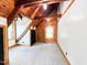 A bright bedroom has a log wall, white walls, carpeted flooring, and windows at 1283 Ennis Rd, Angier, NC 27501