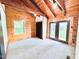 A bedroom has a gray carpet, wood walls, white walls, and exterior access at 1283 Ennis Rd, Angier, NC 27501