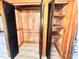 A spacious closet featuring wood shelves, wood paneling, and black shutter doors for storage and organization at 1283 Ennis Rd, Angier, NC 27501