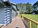 Wide wood deck with black metal railings runs along the house at 1283 Ennis Rd, Angier, NC 27501