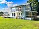 Exterior view of the two-story home showing the extensive decking and sunroom at 1283 Ennis Rd, Angier, NC 27501