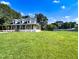 Lovely home with a welcoming porch, expansive lawn, and a storage shed at 1283 Ennis Rd, Angier, NC 27501