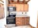 This kitchen features wood cabinets, stainless steel appliances, and a countertop to create a charming and functional space at 1283 Ennis Rd, Angier, NC 27501