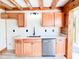 Cozy kitchen area featuring oak cabinetry, stainless steel appliances, and a modern sink at 1283 Ennis Rd, Angier, NC 27501