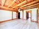 Large living room featuring wood ceiling beams, wood flooring, and white paneled walls at 1283 Ennis Rd, Angier, NC 27501