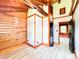 A log-walled living room has white walls, light-colored floors, and a wood beam ceiling at 1283 Ennis Rd, Angier, NC 27501