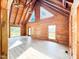 Vaulted ceiling and exposed beams accent this living space with natural light and wood finishes at 1283 Ennis Rd, Angier, NC 27501