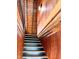 Staircase with wood paneling, black railings, and wood treads, creates a warm and inviting passage to the upper level at 1283 Ennis Rd, Angier, NC 27501