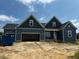 Charming two-story home with a two-car garage, featuring a modern design and inviting curb appeal at 129 Retreat Run, Smithfield, NC 27577