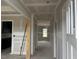 Hallway with white trim and view of a window at the end of the hall, and a doorway to the left at 129 Retreat Run, Smithfield, NC 27577