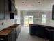 Spacious kitchen area with dark cabinets, lots of countertop space, and an open space to the back at 129 Retreat Run, Smithfield, NC 27577