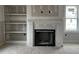Living room area featuring a white fireplace, built in shelves, and a window on the right at 129 Retreat Run, Smithfield, NC 27577
