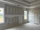 Spacious primary bedroom features two windows that provide great natural light and a simple interior door at 129 Retreat Run, Smithfield, NC 27577