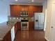 Well-equipped kitchen with stainless steel appliances, wood cabinets, and granite countertops at 1304 Cozart St # 119, Durham, NC 27704