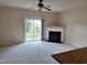 Spacious living room featuring a fireplace, sliding glass doors to the backyard and a ceiling fan at 1304 Cozart St # 119, Durham, NC 27704