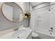 Modern bathroom with white subway tile, a round mirror, and a decorative shelf at 1324 Sandybrook Ln, Wake Forest, NC 27587
