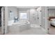 This bathroom features a soaking tub and a glass-enclosed shower with white marble at 1324 Sandybrook Ln, Wake Forest, NC 27587